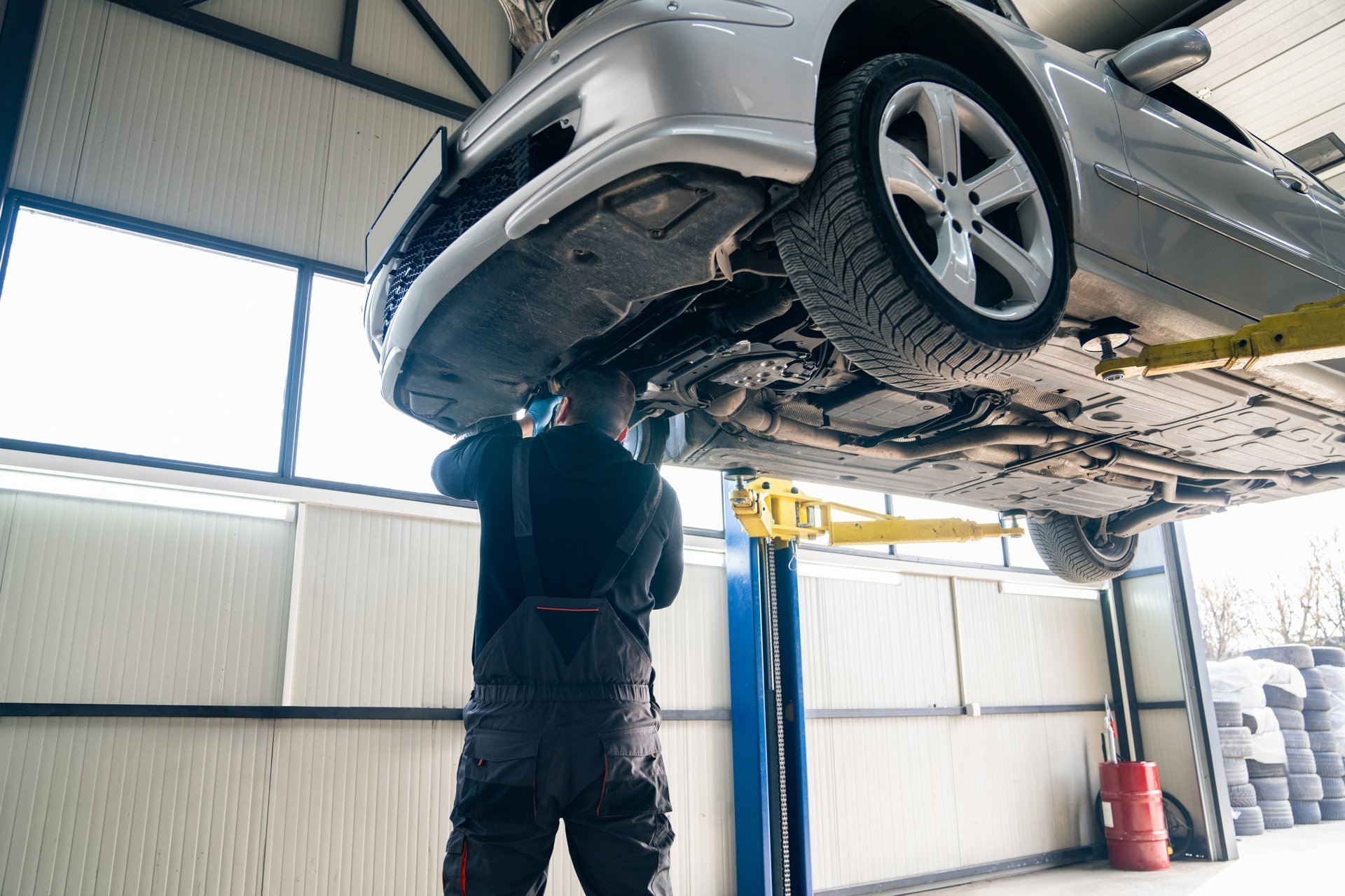 Mechanic working on car suspension in professional auto repair shop
